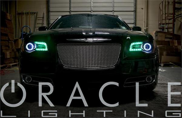 Front view of a Chrysler 300C with white LED halos and green DRLs.