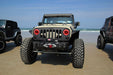 Front end of a Jeep Wrangler JK with red LED headlight halos installed.