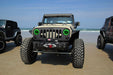 Front end of a Jeep Wrangler JK with green LED headlight halos installed.