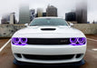 Front end of a white Dodge Challenger with purple LED headlight halo rings installed.