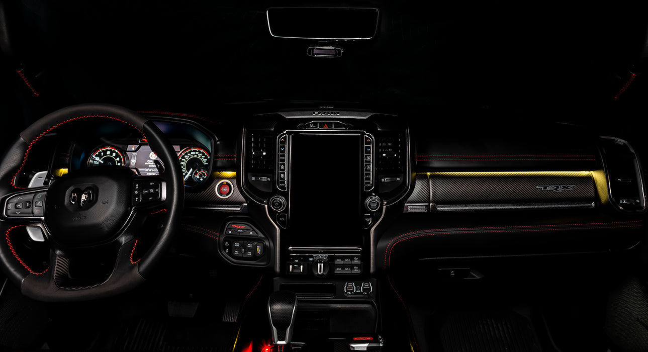 View of a RAM TRX dashboard from the backseat with yellow LED ambient lighting kit.