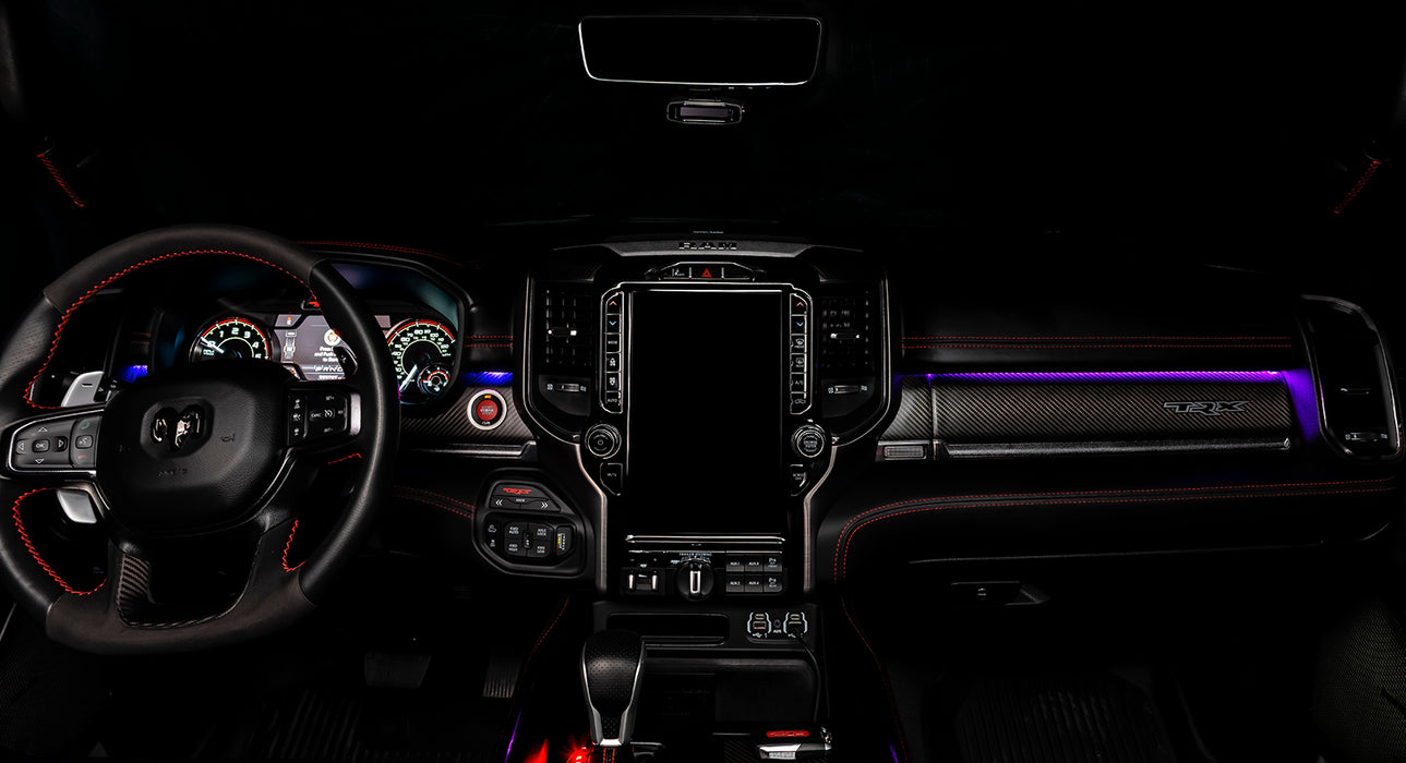 View of a RAM TRX dashboard from the backseat with purple LED ambient lighting kit.