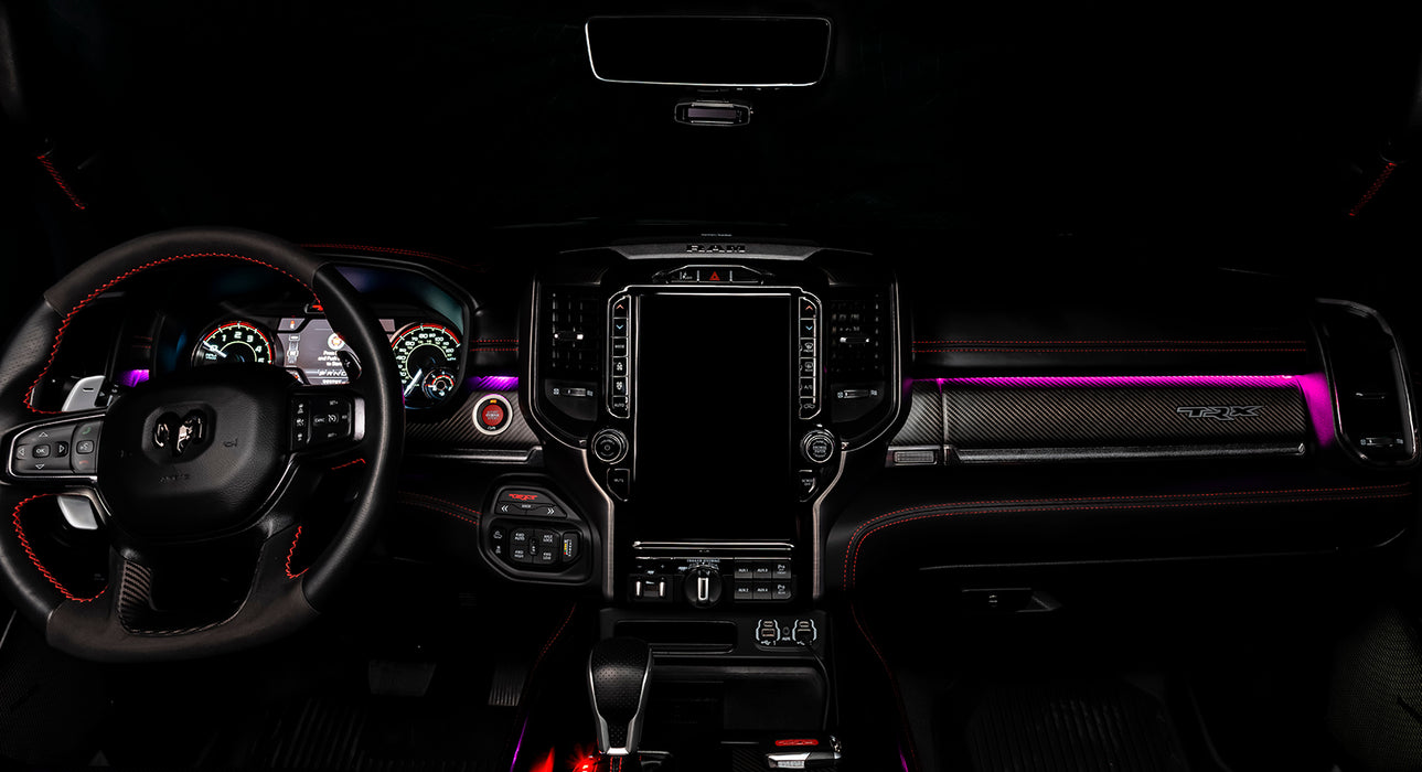 View of a RAM TRX dashboard from the backseat with pink LED ambient lighting kit.