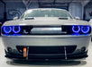 Front end of a Dodge Challenger with blue halo headlights.