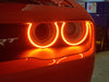 Close-up of Dodge Challenger Headlights with amber LED halo rings.