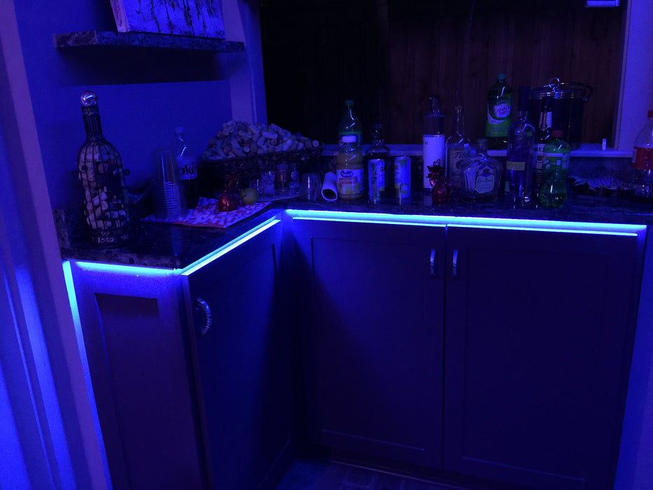 Home bar with blue LED accent lighting underneath the counter