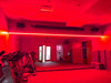 Workout room with red LED lighting strips above the mirrors.