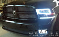 Front end of a Dodge Ram with white LED headlight and fog light halo rings.