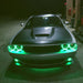 Front end of a Dodge Challenger with green LED headlight and fog light halo rings.