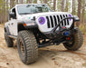 Three quarters view of a Jeep Gladiator with 7" High Powered LED Headlights installed, and purple halo rings on.