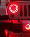 Close-up on the front end of a Jeep with High Performance 20W LED Fog Lights installed, and red halos on.