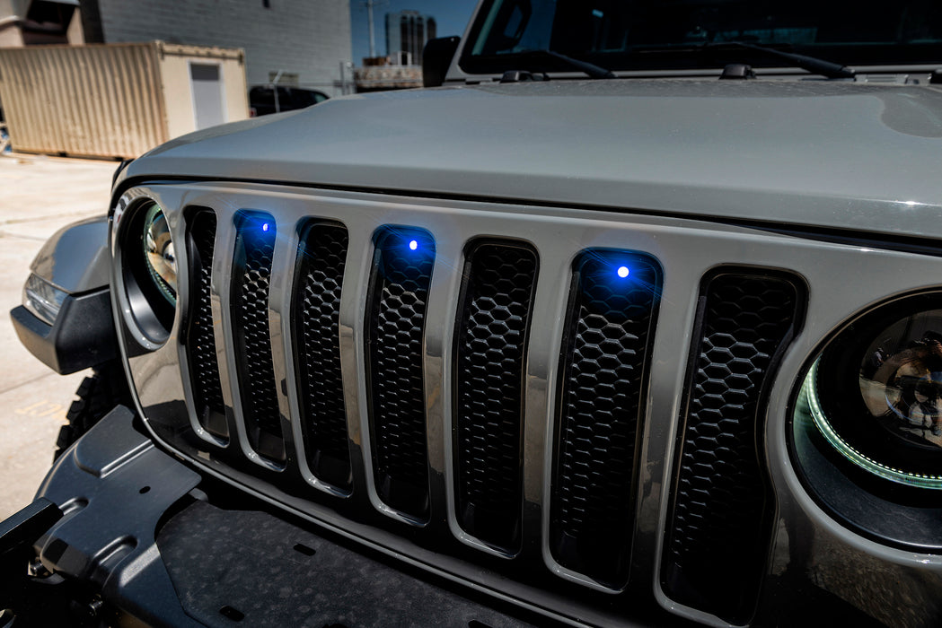 Close-up on the front end of a Jeep Wrangler with blue LED Grill Light Kit.