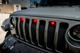 Front end of a Jeep Wrangler JL with red Pre-Runner Style LED Grill Light Kit installed.