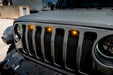 Close-up on the front end of a Jeep Wrangler with amber LED Grill Light Kit installed.