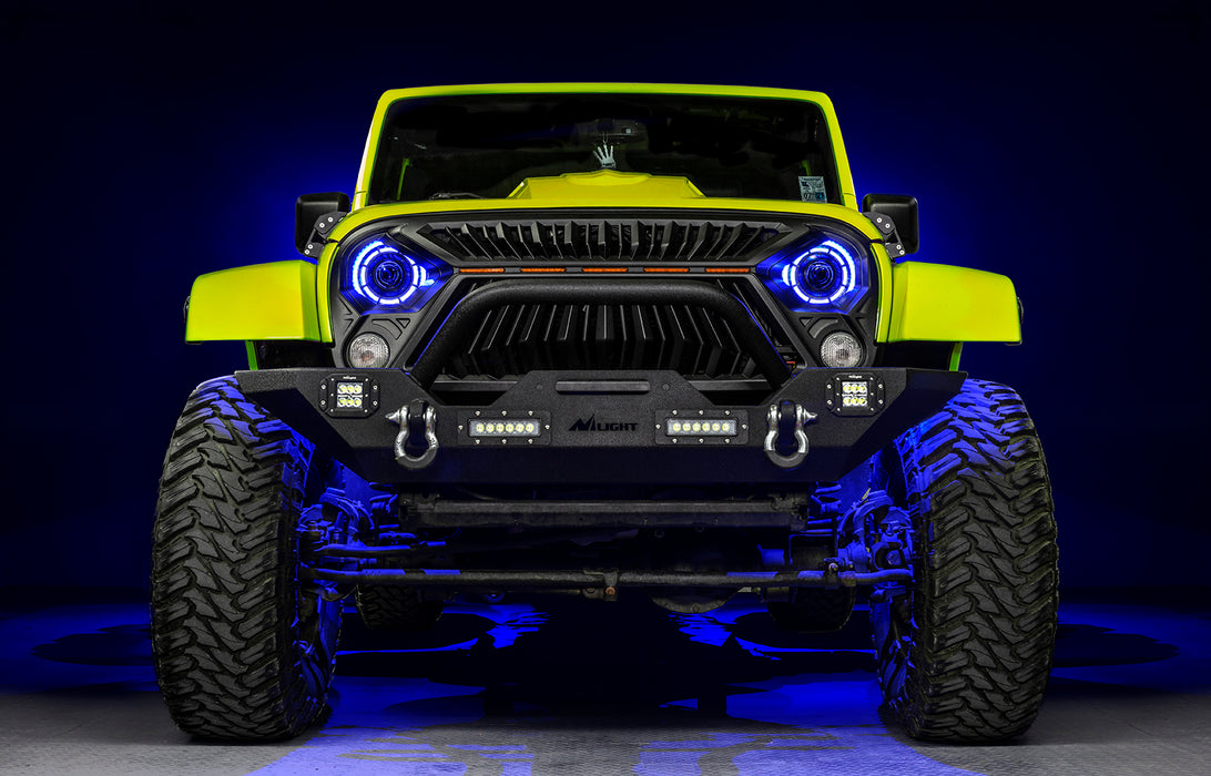 Front view of a yellow Jeep with 7" Oculus Headlights installed, set to blue LEDs.