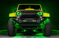 Front view of a yellow Jeep with 7" Oculus Headlights installed, set to green LEDs.