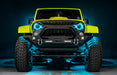 Front view of a yellow Jeep with 7" Oculus Headlights installed, set to cyan LEDs.