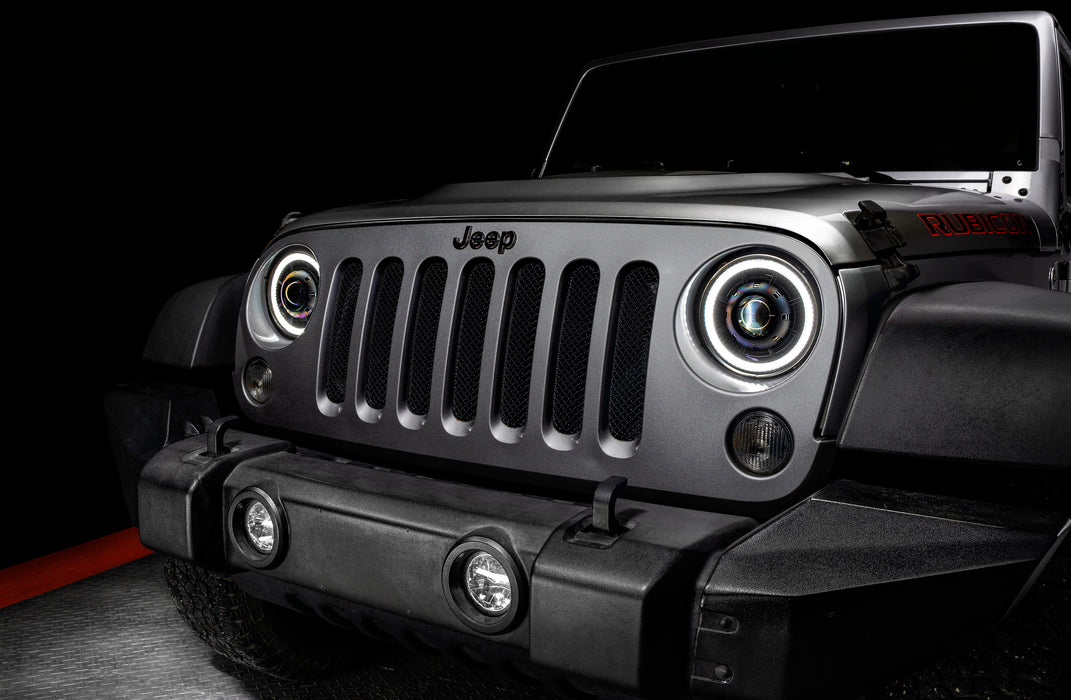 Close-up on the front end of a Jeep Wrangler JK with 7" Oculus Switchback Headlights installed and set to white LED.