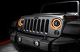 Close-up on the front end of a Jeep Wrangler JK with 7" Oculus Switchback Headlights installed and set to amber LED.