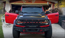 Front view of a red Ford Bronco equipped with the Integrated Windshield Roof LED Light Bar System.