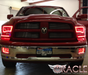Front end of a Dodge Ram with red LED headlight halo rings installed.