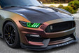 Front end of a Ford Mustang with green headlight halos and DRLs.