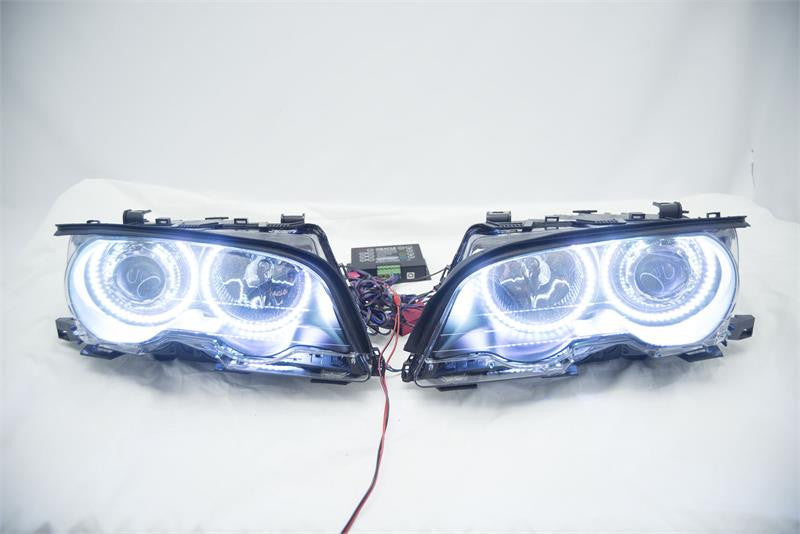 BMW 3 Series headlights with white LED halo rings.