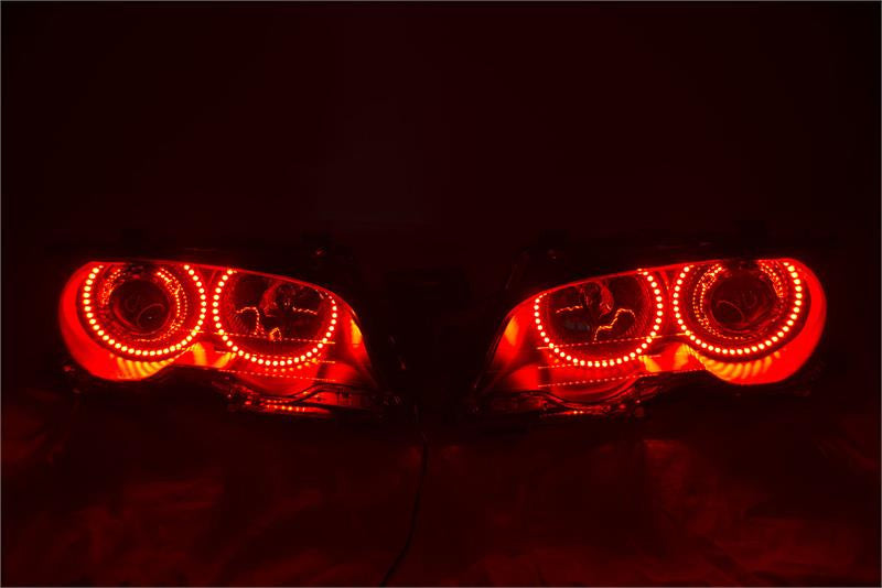 BMW 3 Series headlights with red LED halo rings.