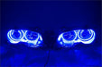 BMW 3 Series headlights with blue LED halo rings.