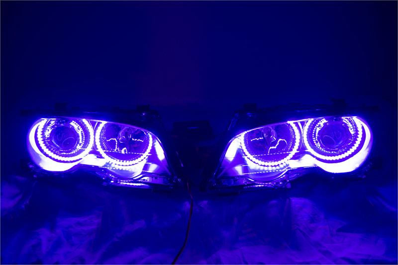 BMW 3 Series headlights with purple LED halo rings.