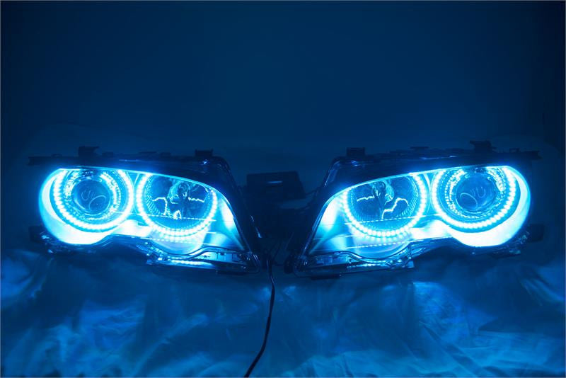 BMW 3 Series headlights with cyan LED halo rings.