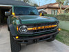 Green Ford Bronco with amber LED illuminated letter badges installed