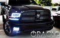 Front end of a black Dodge Ram with white LED headlight and fog light halo rings installed.
