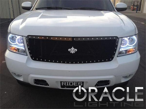 Front end of a Chevrolet Tahoe with white LED headlight halo rings installed.