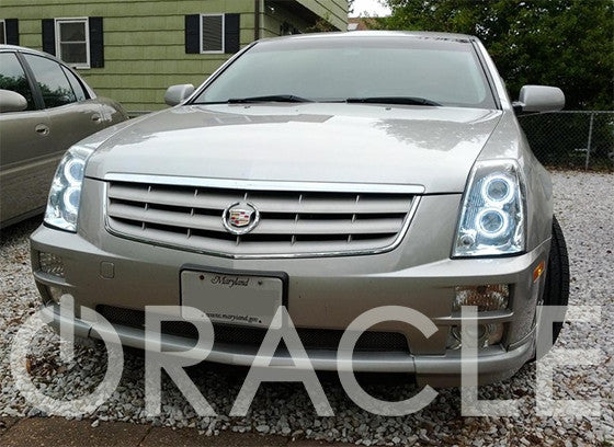 Front end of a Cadillac STS with white LED headlight halo rings.