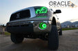 Low aggressive shot of a Toyota Tundra with green LED headlight and fog light halos installed.