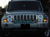 Front end of a Jeep Commander with white LED headlight halo rings installed.