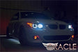 Three quarters view of a BMW 5 Series with white LED headlight halo rings.