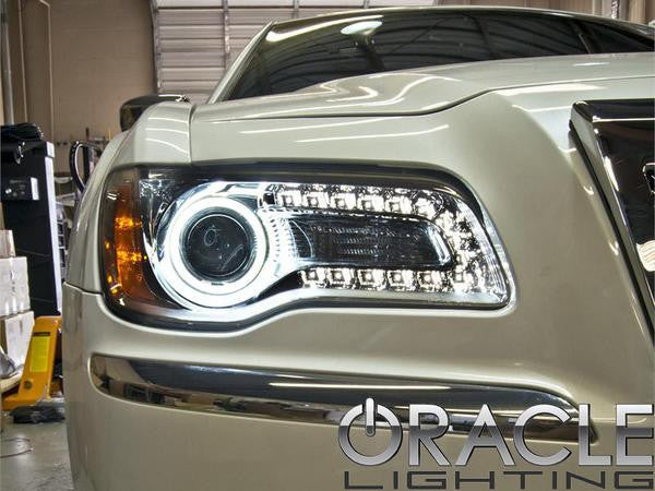 Close-up of white LED headlight halo rings installed on a Chrysler.