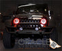 Front end of a Jeep Wrangler with red LED headlight halo rings installed.