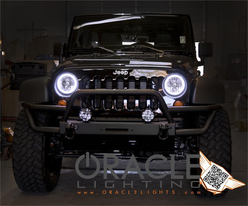 Front end of a Jeep Wrangler with white LED headlight halo rings installed.