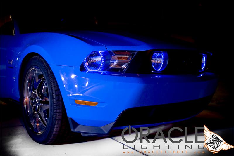 Front end of a Ford Mustang with blue LED headlight halo rings installed.