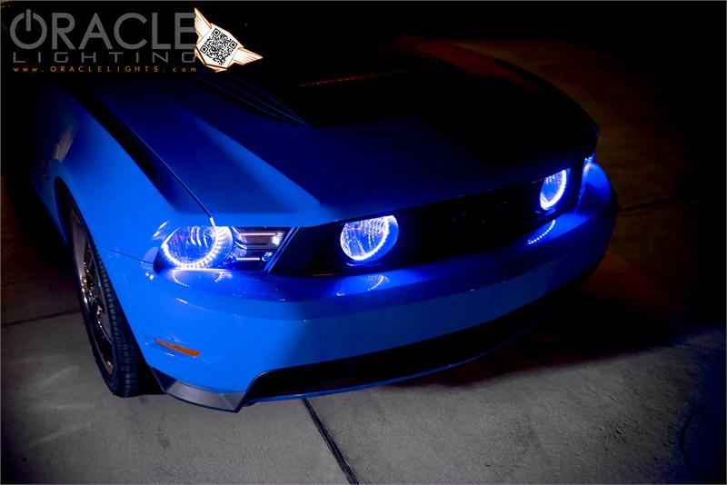 Front end of a Ford Mustang with blue LED headlight and fog light halos installed.