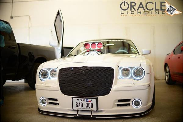 Front end of a white Chrysler 300C with white LED headlight and fog light halo rings installed.