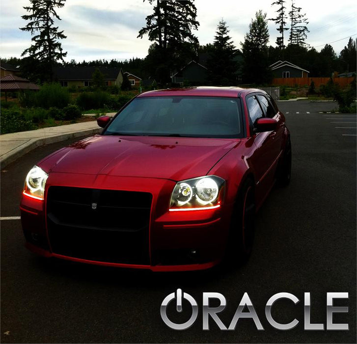 Front end of a Dodge Magnum with white LED headlight halo rings installed.