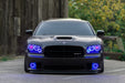 Black charger outside with blue headlight and fog light halos