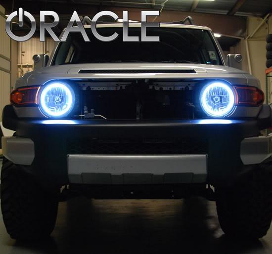 Front view of a Toyota FJ Cruiser with white LED headlight halo rings installed.