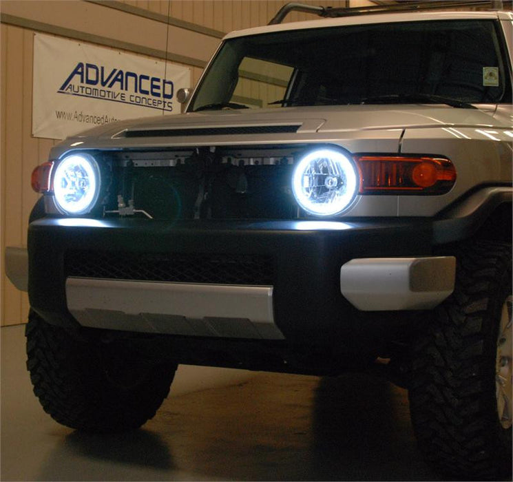 Front end of a Toyota FJ Cruiser with white LED headlight halos installed.