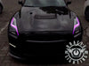 Black Nissan GT-R with pink headlight DRLs.