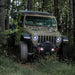 Jeep Gladiator driving in a forest with Oculus Headlights installed.